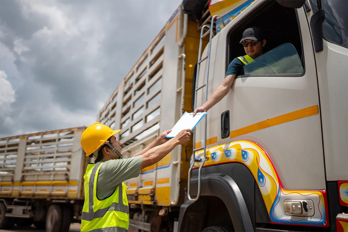a man in a yellow vest handing a clipboard