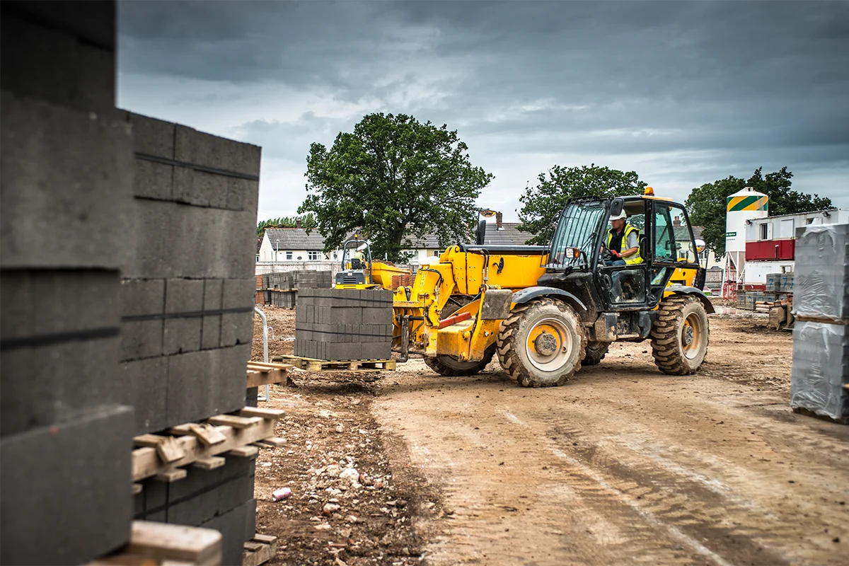 tractor building materials on construction site